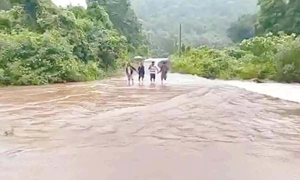 Floodwater overflowing on the culvert near Pullangi Chelakavidhi in Maredumilli mandal in Rampachodavaram