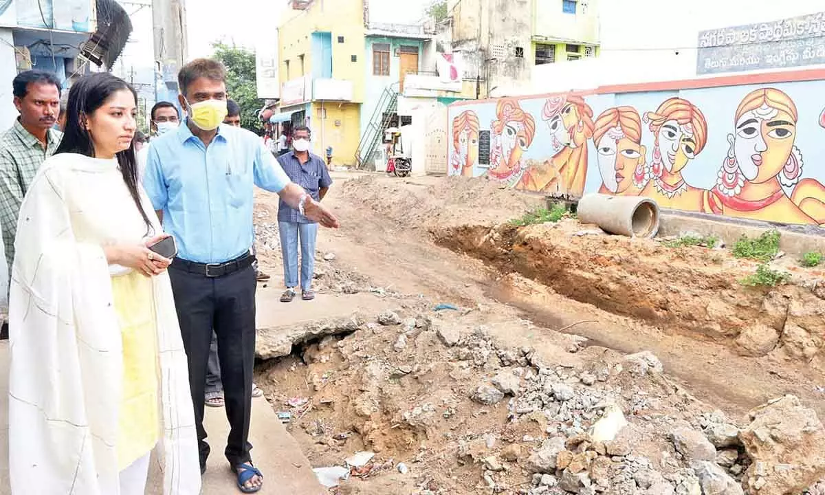 Superintendent Engineer Mohan briefing the progress of road under bridge works to Municipal Commissioner Anupama Anjali at RC Road in Tirupati on Thursday.