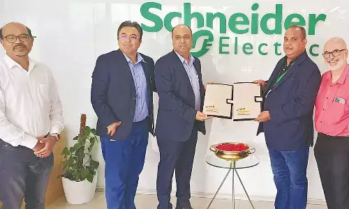 Aman Kapoor, CEO - Airport Land Development, GMR Group and Javed Ahmad, Senior Vice President, Global Supply Chain, International region, Schneider Electric showing the agreement document here on Thursday