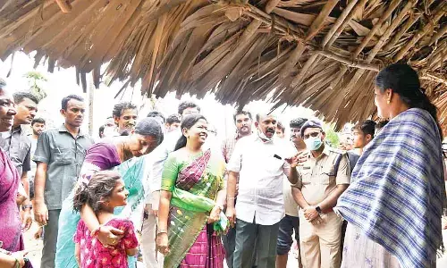 Home Minister Taneti Vanitha and District Collector K Madhavi Latha convincing a woman to shift to a relief camp, in Madduru Lanka on Thursday