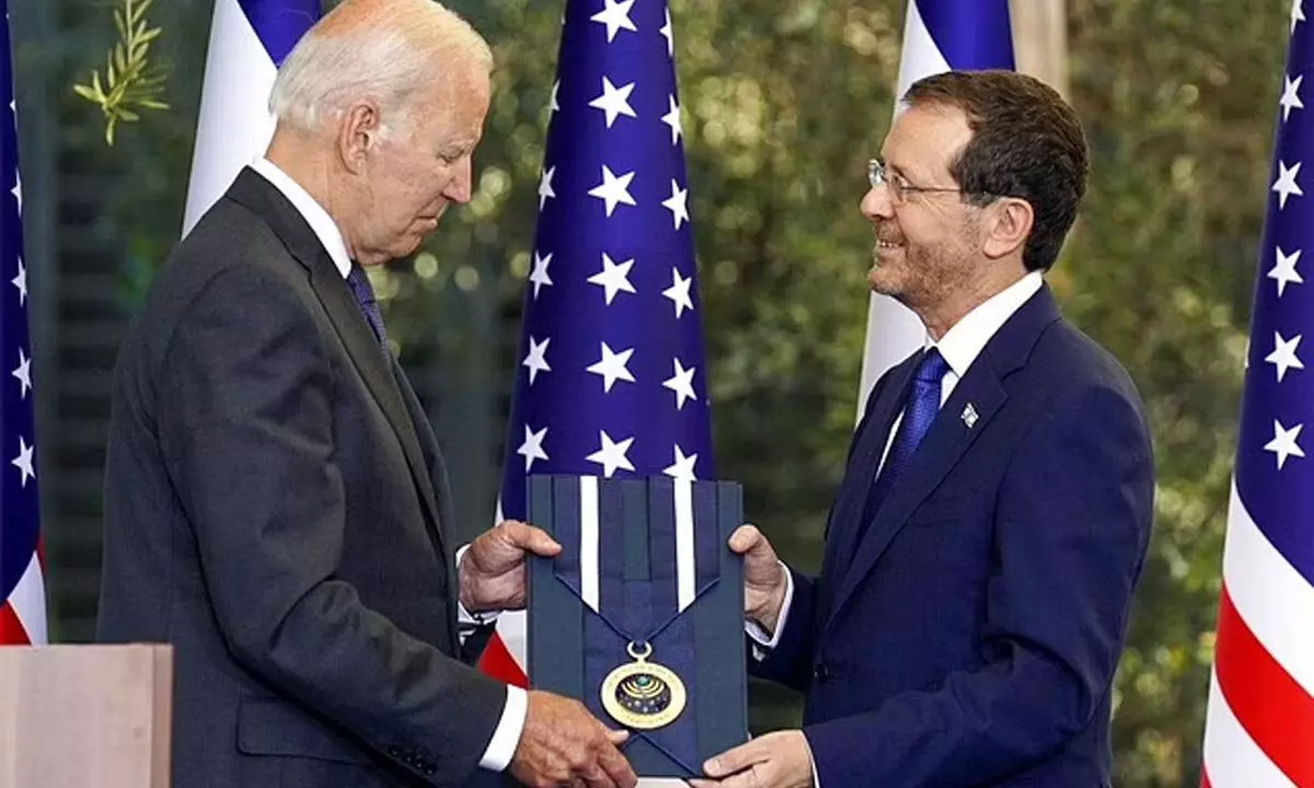 Biden receives Israels top civilian honour, the presidential medal of honour, from President Isaac Herzog on Thursday.