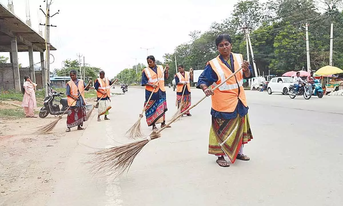 Municipal sanitary contract workers attending duties in Tirupati on Friday