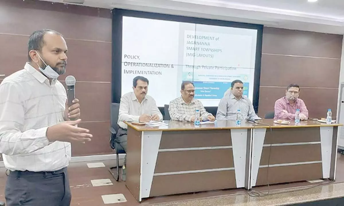 AP Urban Infrastructure Development Asset Management project manager Siddarth explaining about Jagananna Smart Townships at a meeting at CRDA office in Vijayawada on Saturday. AP CRDA commissioner Vivek Yadav (2nd from right) is also seen.
