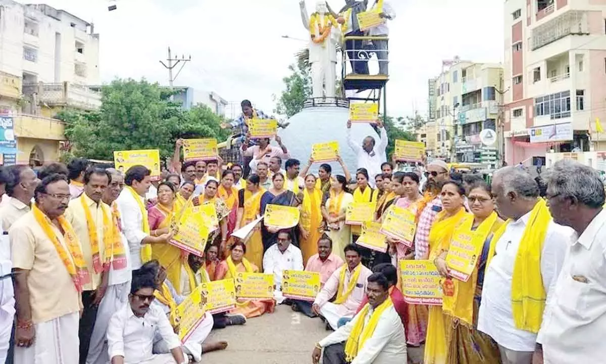 District TDP leaders staging a protest in front of the statue of Dr BR Ambedkar in Ongole on Monday
