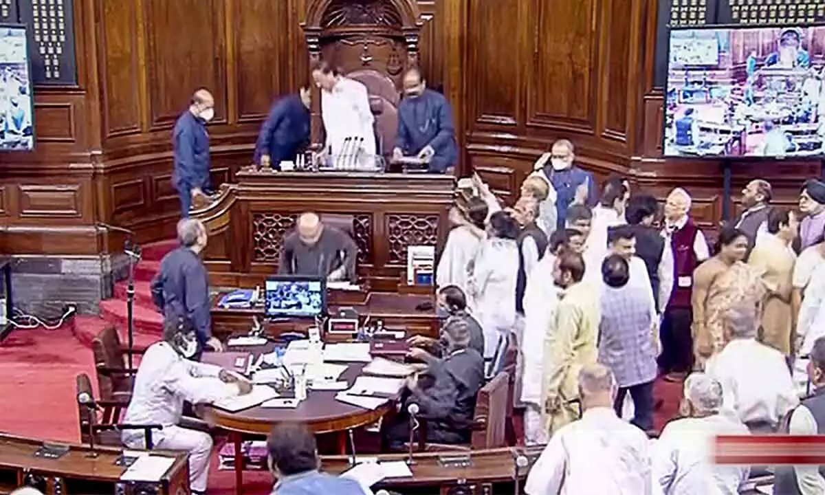 Opposition members protest in the well of the Rajya Sabha, on the first day of Parliaments Monsoon Session, in New Delhi on Monday