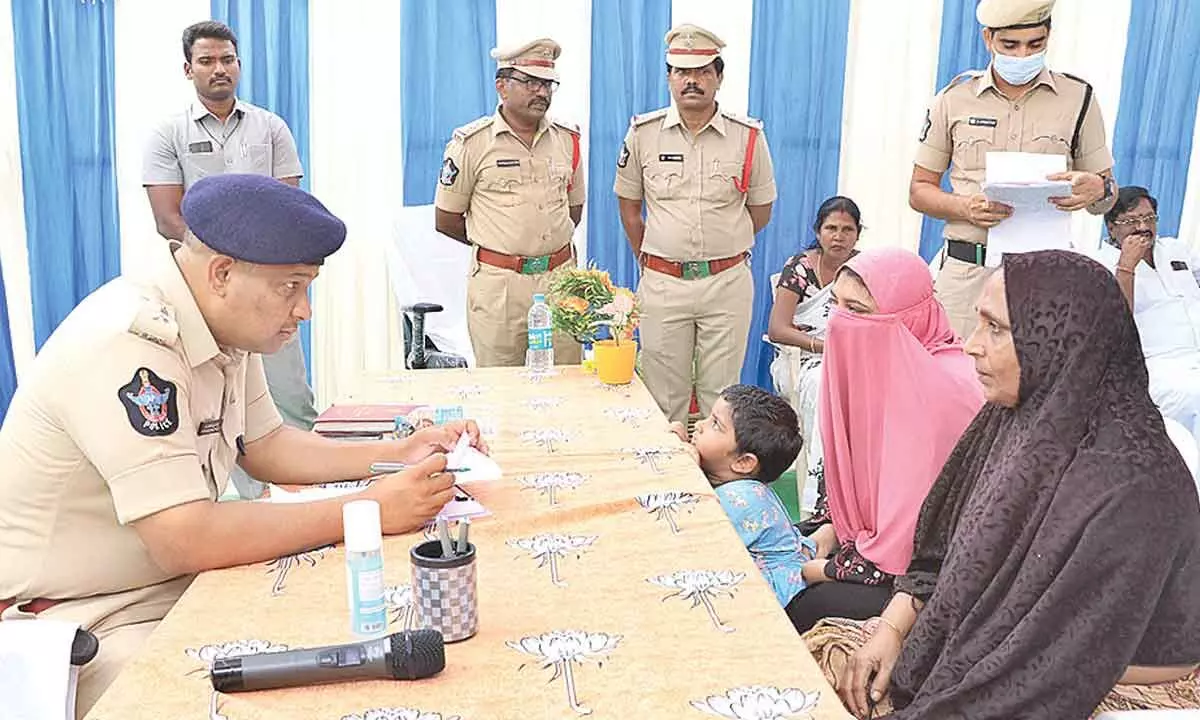 SP P Parameswar Reddy receiving a petition from a woman during Special Spandana held at Naidupeta police station on Monday