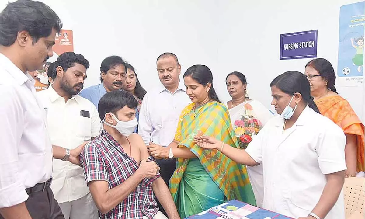 Mayor Dr R Sirisha administering precautionary dose to a beneficiary in Tirupati on Monday. Collector K Venkataramana Reddy, DM&HO Dr U Sree Hari and others are seen.