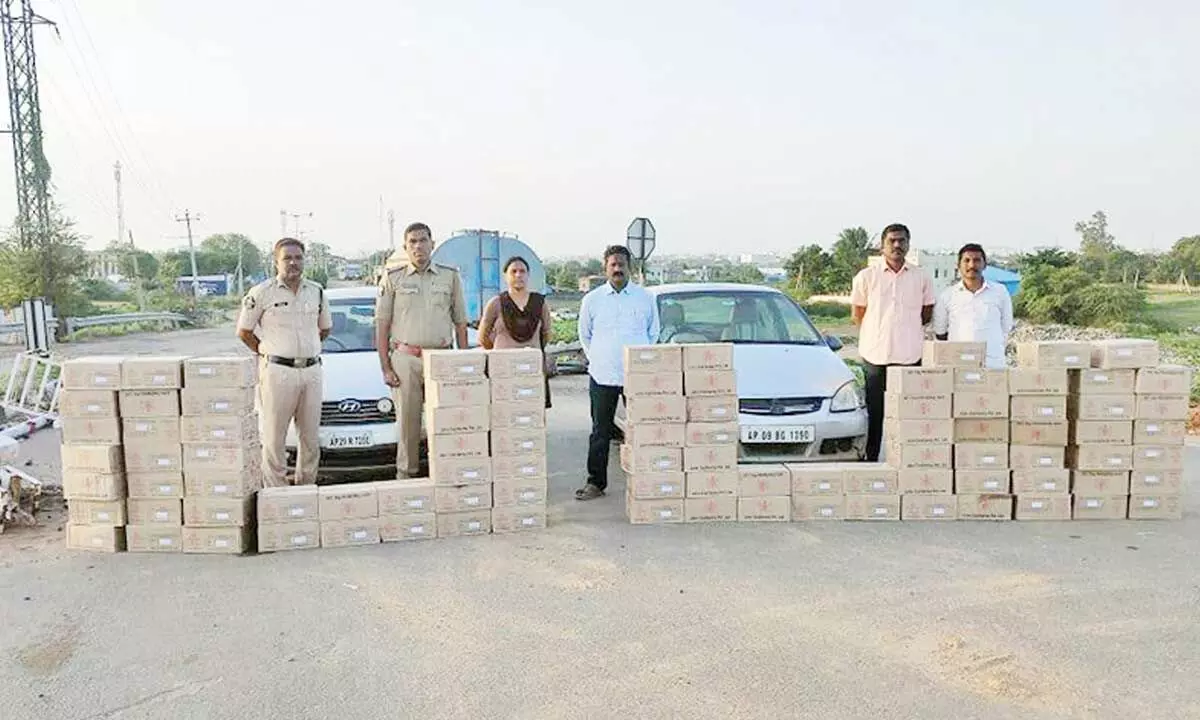 SEB Circle Inspector M Manjula and her staff with the seized liquor cartons at Panchalingala border check-post on Tuesday
