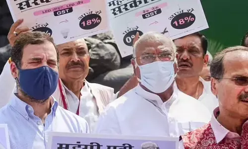 Congress MP Rahul Gandhi with party and other opposition MPs during a protest against inflation and increase in GST on food items, near the Gandhi statue at Parliament. (Photo | PTI)