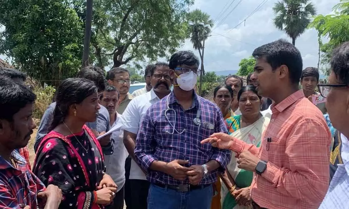 District Collector Anudeep Durishetty interacting with tribal flood victims at Sunnambatti Nagar village in Dummagudem mandal in Kothagudem district on Wednesday