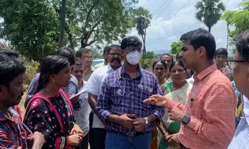 District Collector Anudeep Durishetty interacting with tribal flood victims at Sunnambatti Nagar village in Dummagudem mandal in Kothagudem district on Wednesday