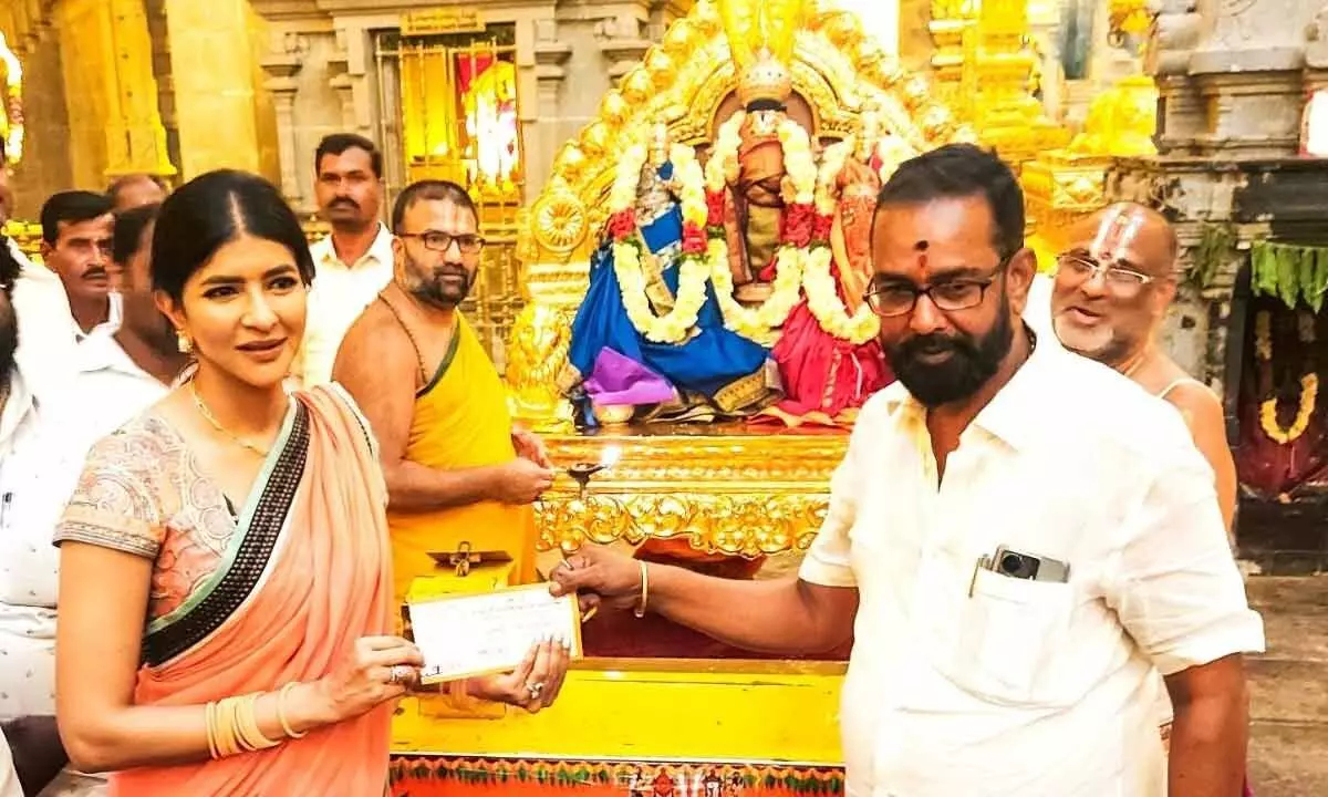 Film actress Manchu Lakshmi buying  Rs 2,000  Shravana Koti Kumkumarchana ticket from  Yadadri Temple staff on Thursday