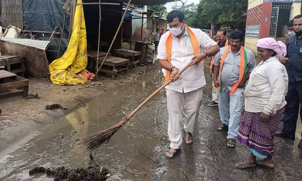 Senior BJP leader Dr Ponguleti Sudhakar Reddy participating in a sanitation drive in Lord Rama temple area in Bhadrachalam on Thursday