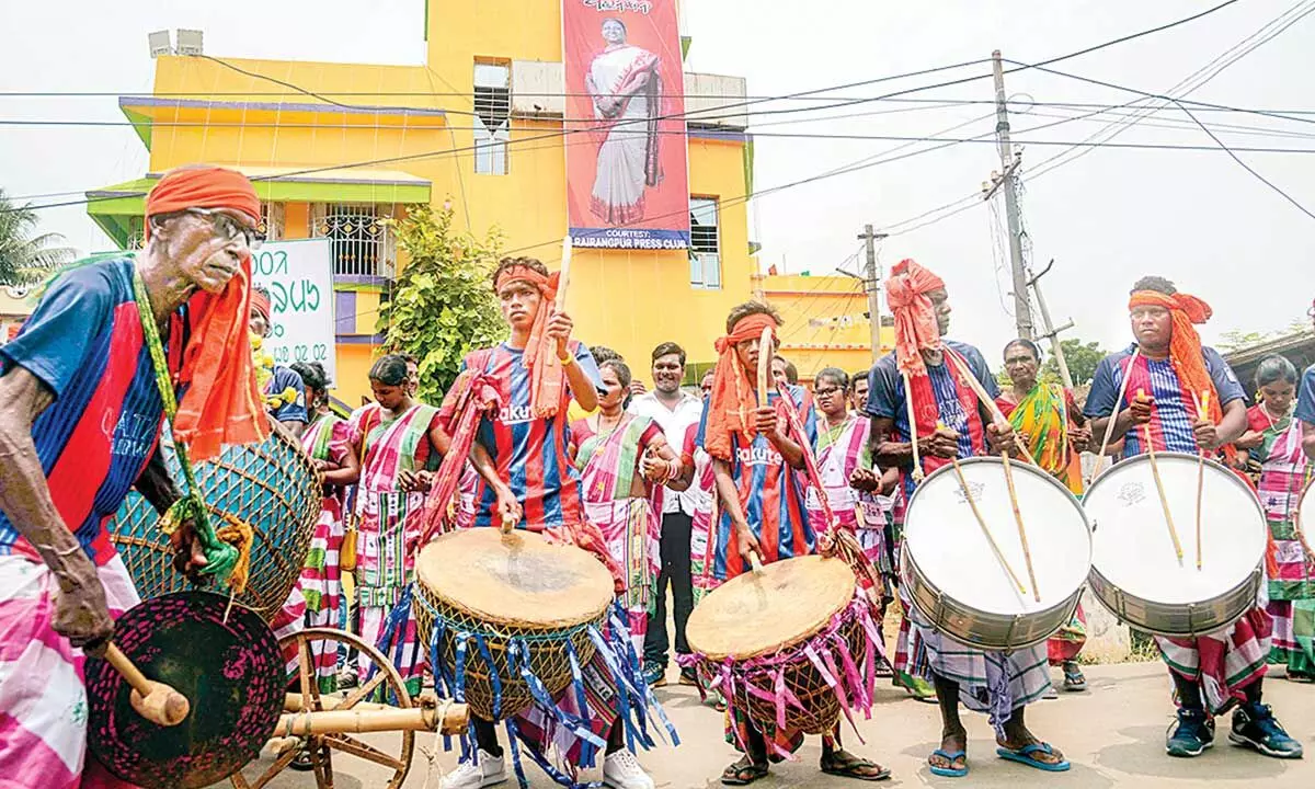Tribal artistes perform as they celebrate victory of NDA candidate Droupadi Murmu as President, near her residence in Rairangpur in Odisha on Thursday