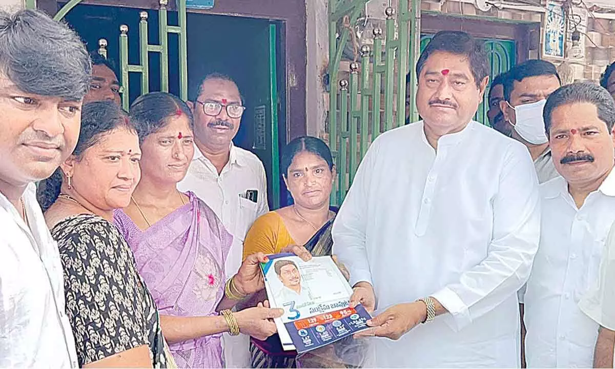 Minister for revenue D Prasada Rao distributes governent publicity material during Gadapa Gadapaku programme in Bhyri village under Srikakulam rural mandal on Thursday