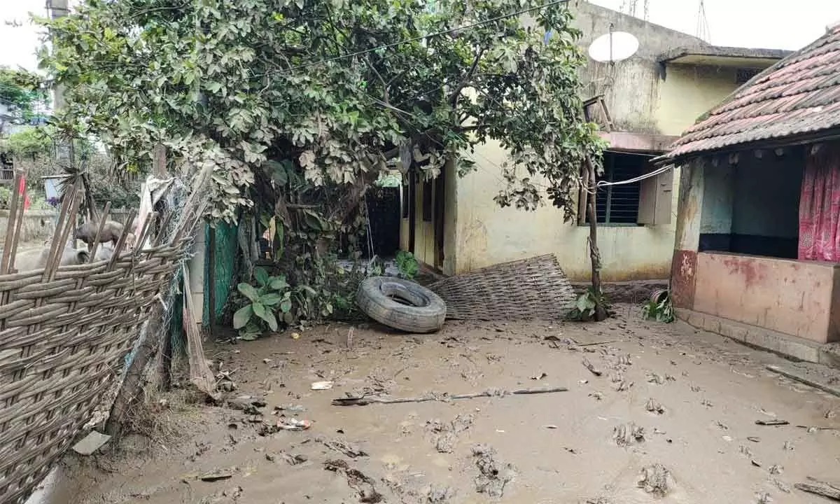 Mud accumulated in front of a house due to flood in Kunavaram village