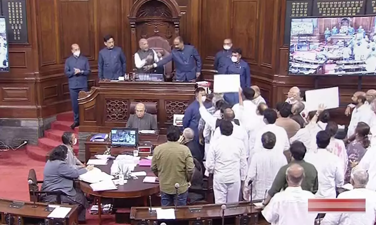 Opposition members protest in Rajya Sabha during the ongoing Monsoon Session of Parliament, in New Delhi on Friday