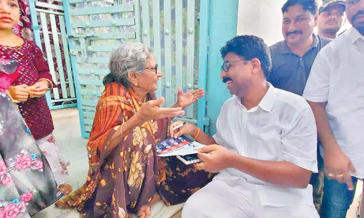 MAUD Minister Dr A Suresh sharing a lighter moment with an old woman, who is explaining Navaratnalu to him at Yerragondapalem on Friday