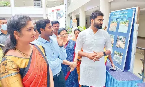 MP Bharat Ram, RMC Commissioner Dinesh Kumar, RUDA Chairperson Sharmila Reddy and others watching a photo exhibition on road repairs in Rajamahendravaram on Friday