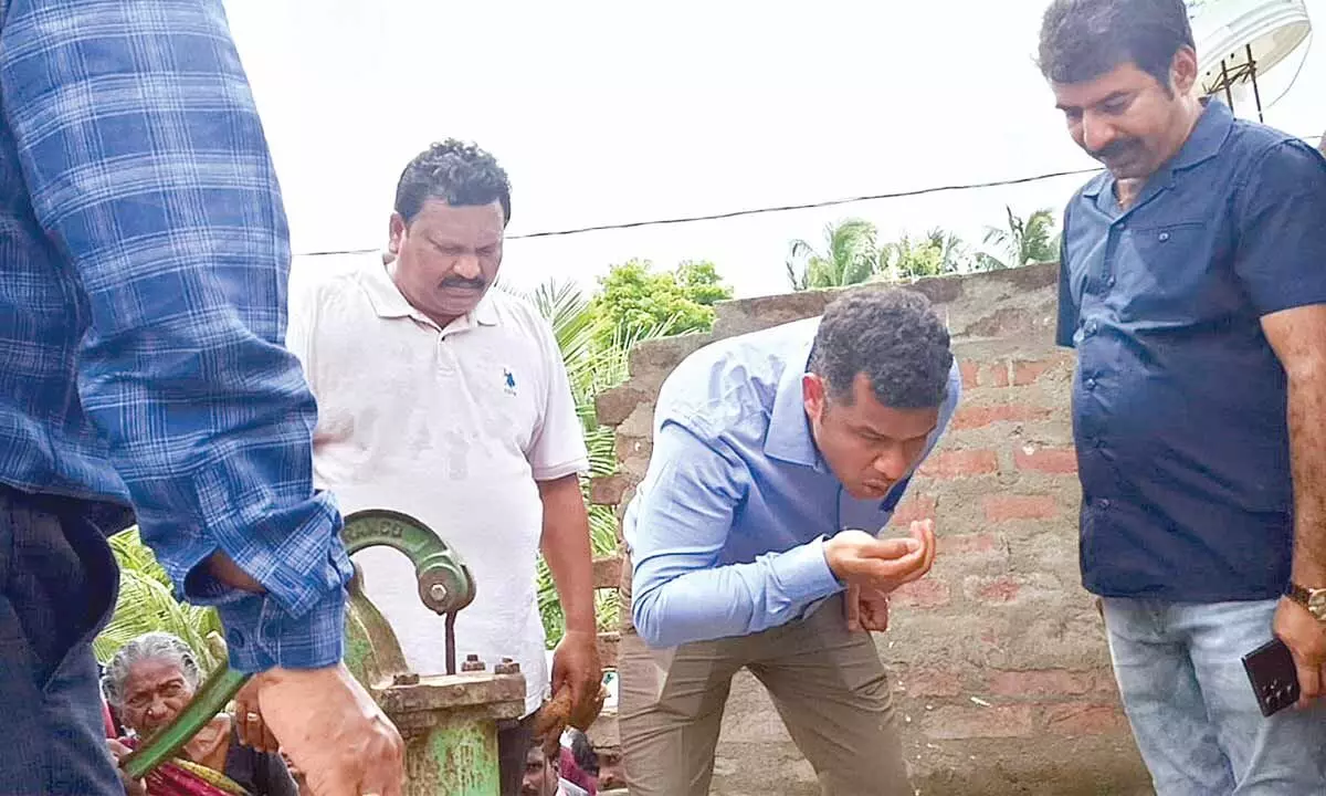 District collector Himanshu Shukla  drinking  the borewater to check  the water quality in flood-affected villages in P Gannavaram mandal of Dr. BR  Ambedkar Konaseema district on Saturday