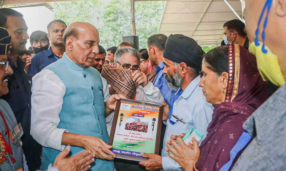 Defence Minister Rajnath Singh felicitates family members of a martyr during a programme commemorating Kargil Vijay Diwas in Jammu on Sunday
