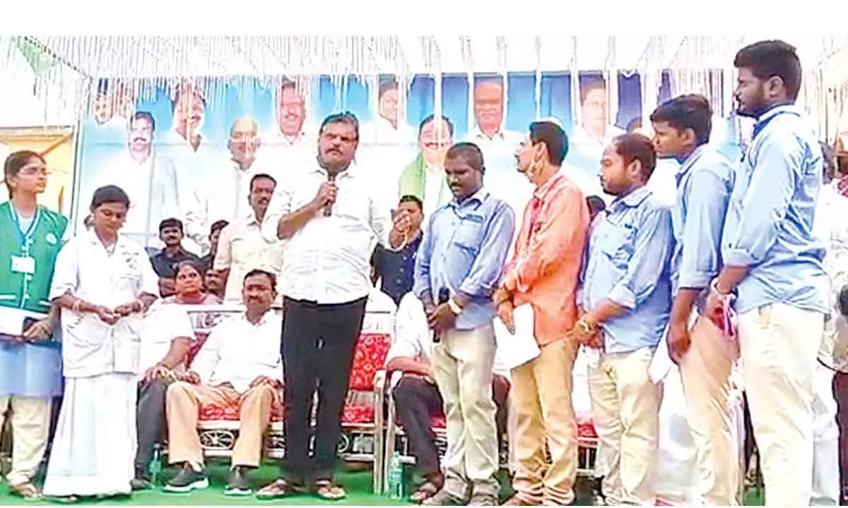 Education Minister Botcha Satyanarayana addressing a meeting in Unguturu village on Sunday