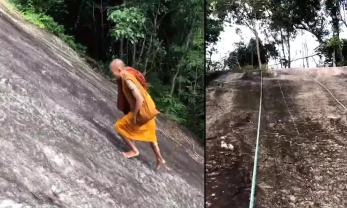 Monk climbs up steep mountain without safety harness. (Image courtesy: Twitter)