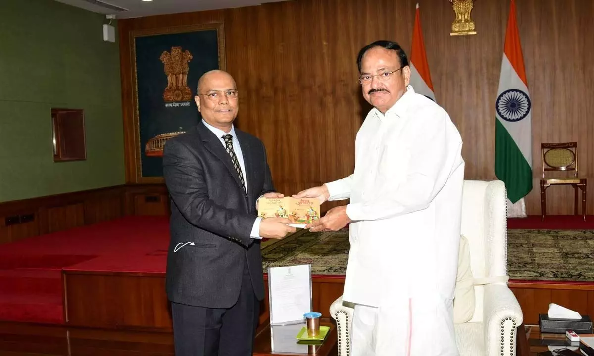 IAS officer Siva Prasad presenting ‘Gita Acharan’ to Vice-President Venkaiah Naidu at Uparashtrapati Bhavan in New Delhi on Wednesday