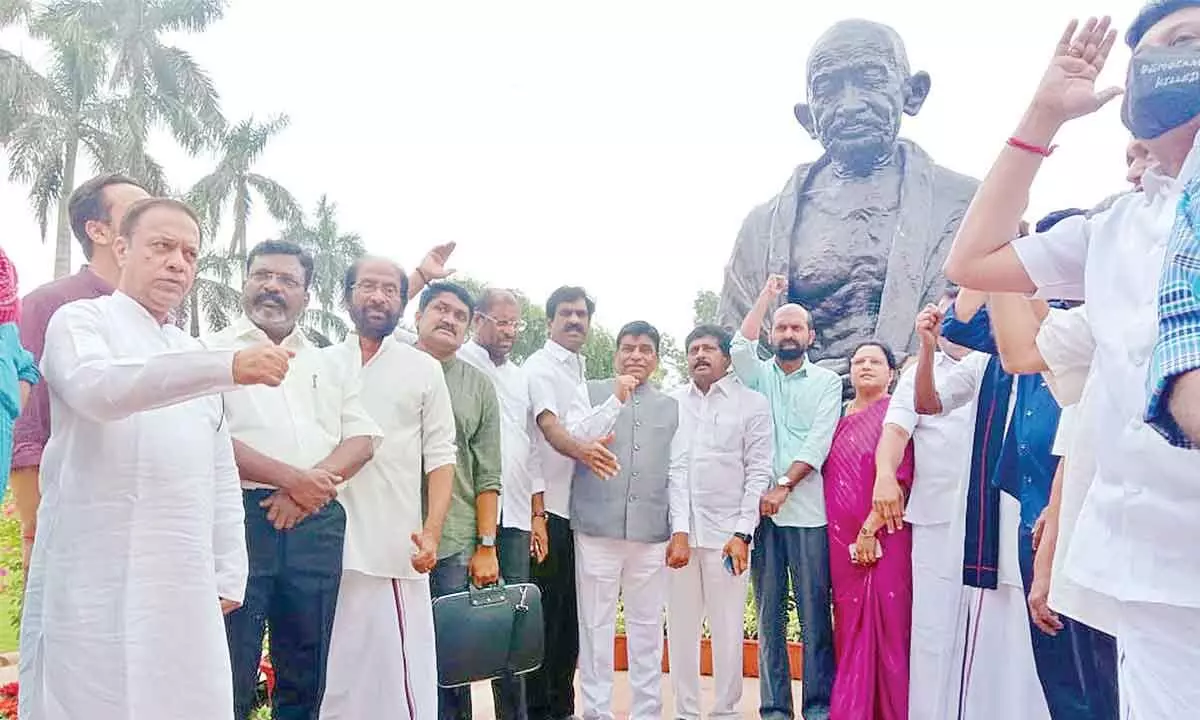 TRS MPs staging protest near Mahatma Gandhi statue on the premises of Parliament on Wednesday