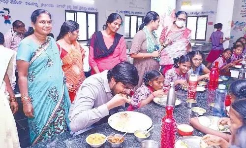 District Collector VP Gautham having launch with girl students at Social Welfare Residential School and College at Kallur on Wednesday