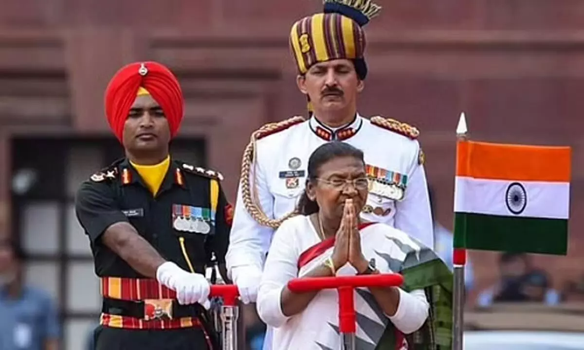 President Droupadi Murmu during a guard of honour by the Tri-services personnel at the forecourt of the Rashtrapati Bhavan, in New Delhi. (Photo | PTI)