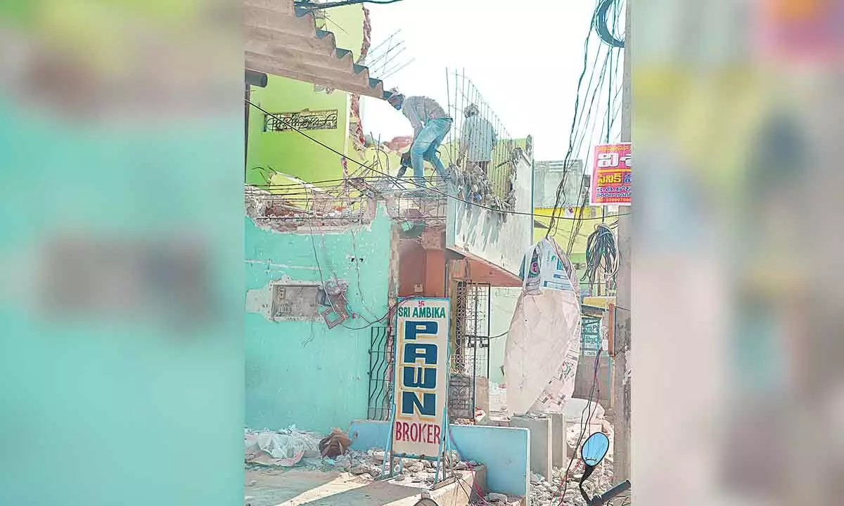 The residents of Korlagunta Maruthinagar Road demolishing their houses as part of road widening in Tirupati on Thursday