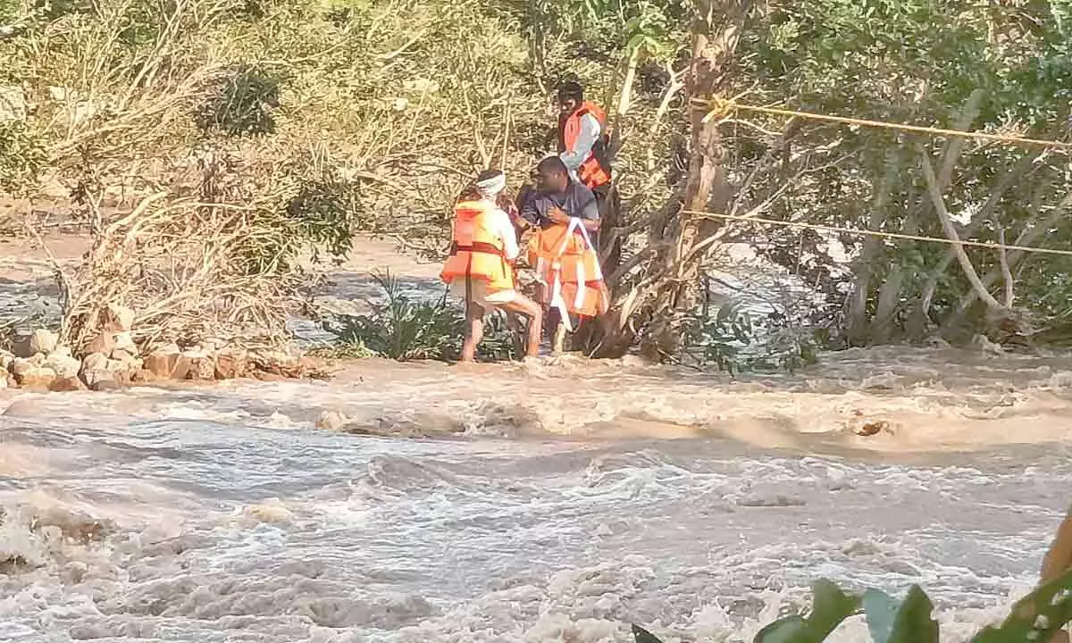 NDRF personnel rescuing the stranded persons in Kamareddy district on Thursday