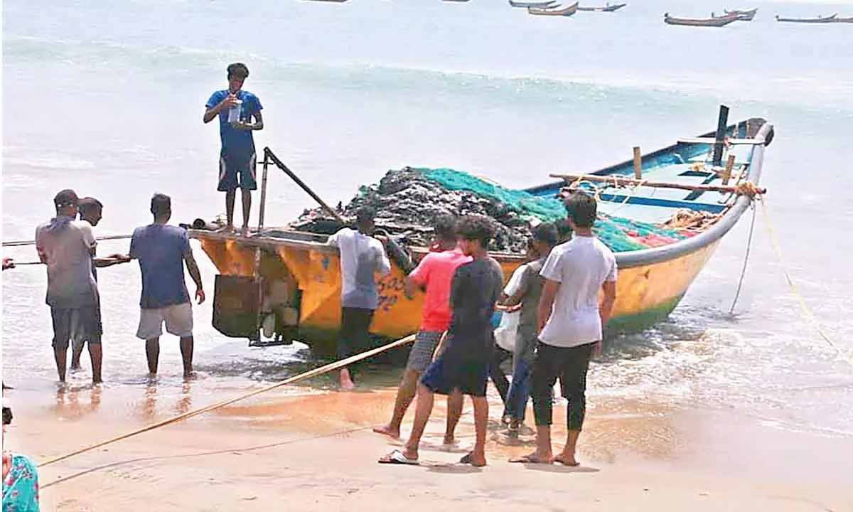A boat which was set on fire during a clash between fishermen communities in Visakhapatnam on Friday