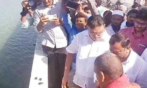 Minister for Water Resources Ambati Rambabu performing puja to Krishna River at Pulichintala Project site in Palnadu district on Friday. MLA Namburu Sanakara Rao is also seen