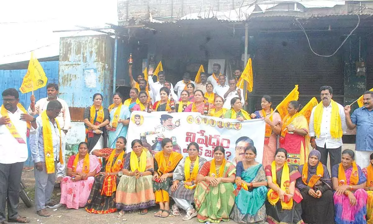 Telugu Mahila leaders and cadre staging a protest at the liquor shop run by the State government in Ongole on Saturday