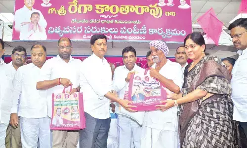 Group of MPs and MLAs distributing essential commodities kits to the flood-affected people at Pinapaka on Saturday