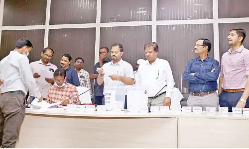 District Collector Rahul Sharma allocating VROs to other departments through lottery system in Nalgonda on Monday