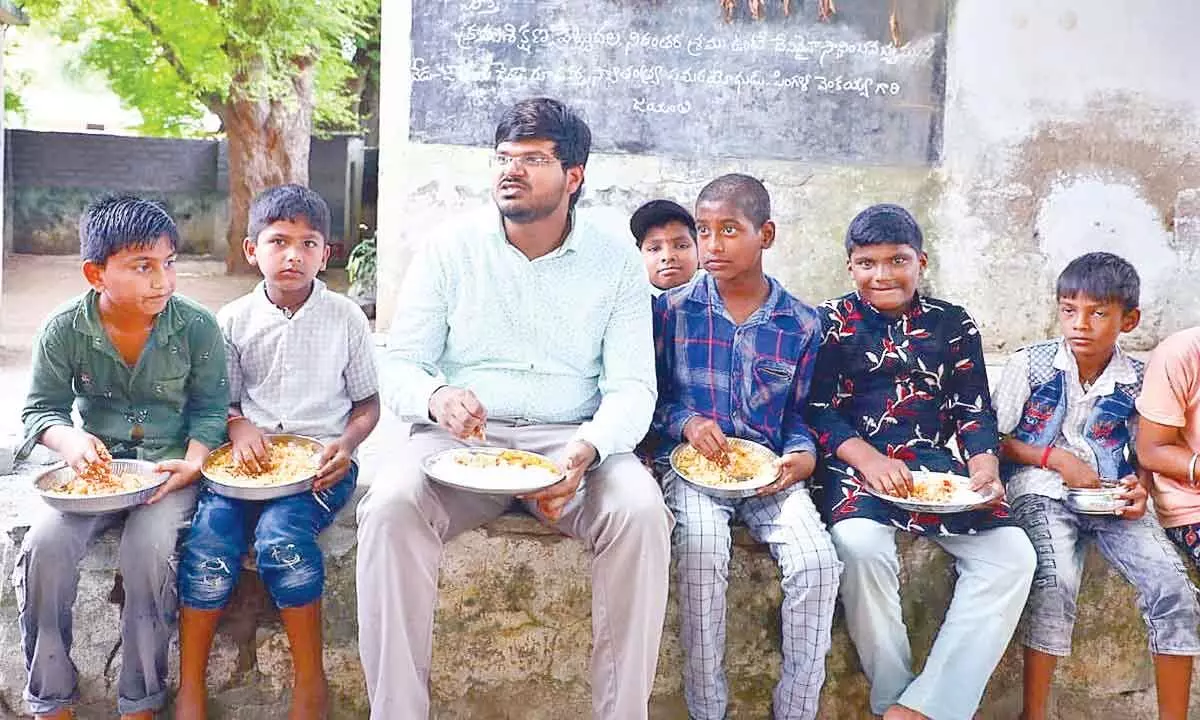 District Collector VP Gautham having launch with students at ZP School in Mallemadugu village in Khammam district on Tuesday