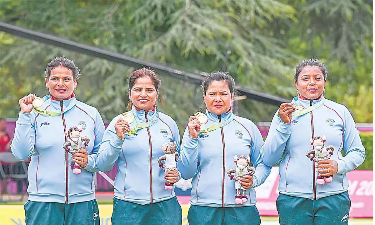 Indias Lovely Choubey, Pinki, Nayanmoni Saikia and Rupa Rani Tirkey pose for photos during a presentation ceremony after winning the Lawn Bowls Womens Fours match against South Africa at the Commonwealth Games in Birmingham on Tuesday.