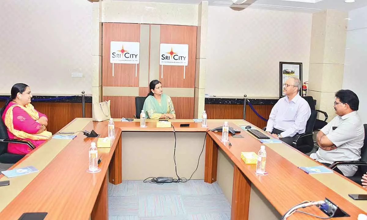 Sri City president (operations) Satish Kamat briefing M Gauthami, CEO, Electronics Manufacturing Clusters, Tirupati on the developments at Sri City during her visit on Thursday.  S S Sony, Zonal Manager, APIIC, Tirupati, Ravindra Sannareddy, Founder Managing Director, Sri City, are also seen.
