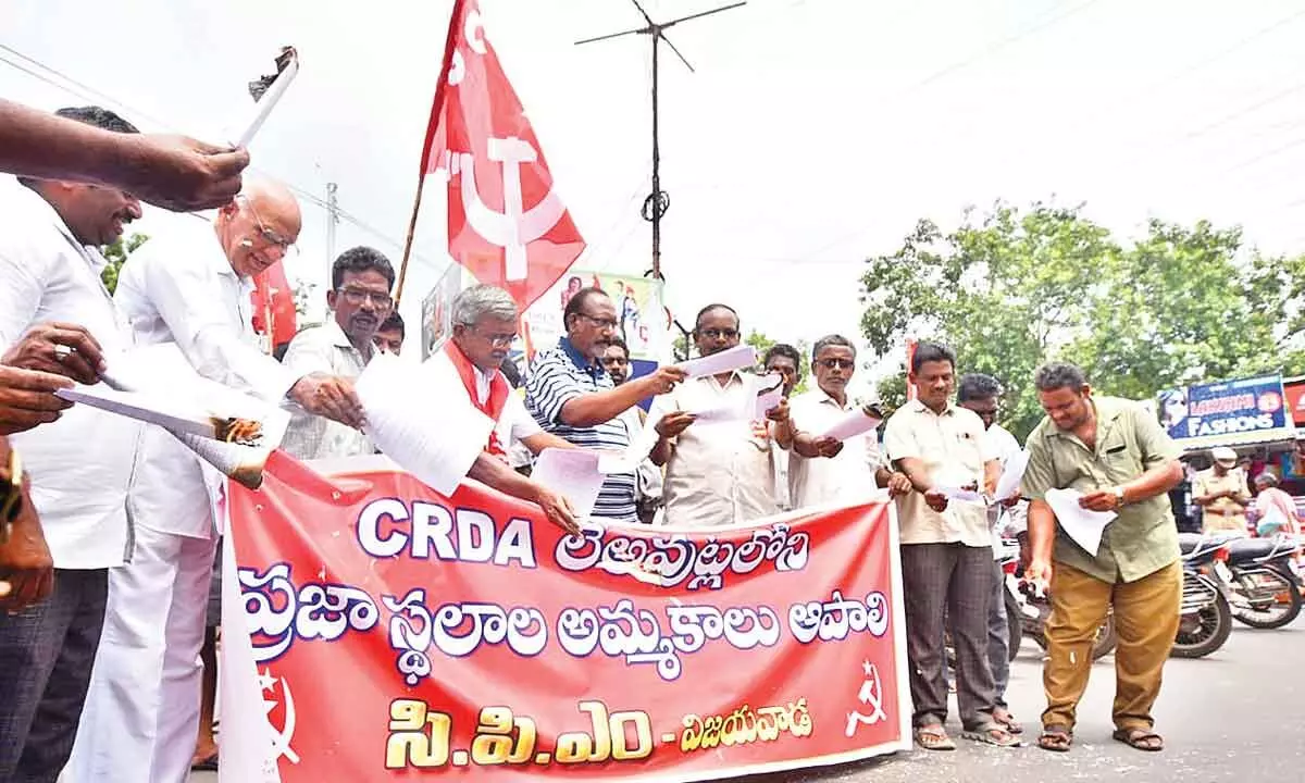 CPM activists burning the copies of the GO 390 as part of their protest, before the CRDA office in Vijayawada on Thursday