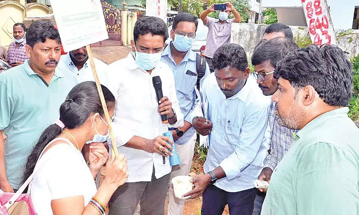 GVMC Commissioner G Lakshmisha checking the presence of a larvae in a water container at a residence in Visakhapatnam on Friday