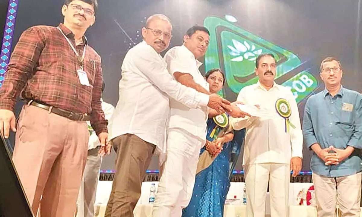 Minister for agriculture and cooperation K Govardhan Reddy (second from right) handing over award to DCCB chairman K Rajeswara Rao