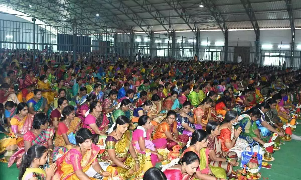 Women devotees participating at Mass Varalakshmi Vratam in Srisailam temple on Friday