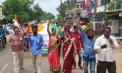 Secretariat staff taking out a rally with a 300-feet national flag in Gokavaram on Friday