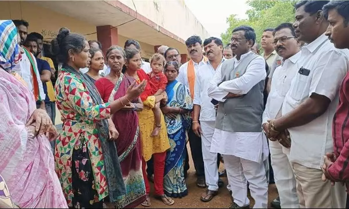 BJP leader G Vivek Venkataswamy speaking with Yellampalli land evacuees in Jagtial district on Monday