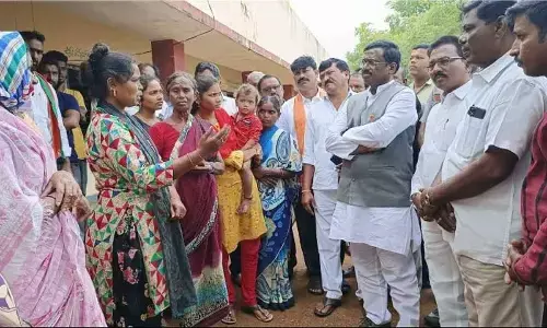 BJP leader G Vivek Venkataswamy speaking with Yellampalli land evacuees in Jagtial district on Monday