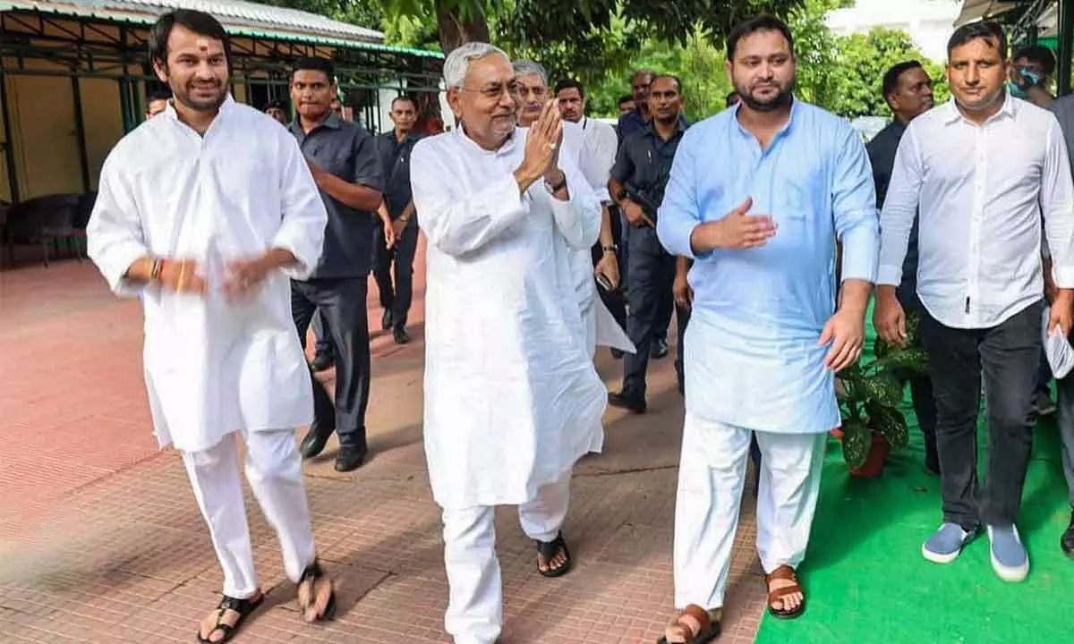 Janata Dal (United) leader Nitish Kumar with Rashtriya Janata Dal leaders Tejashwi Yadav and Tej Pratap, in Patna on Tuesday