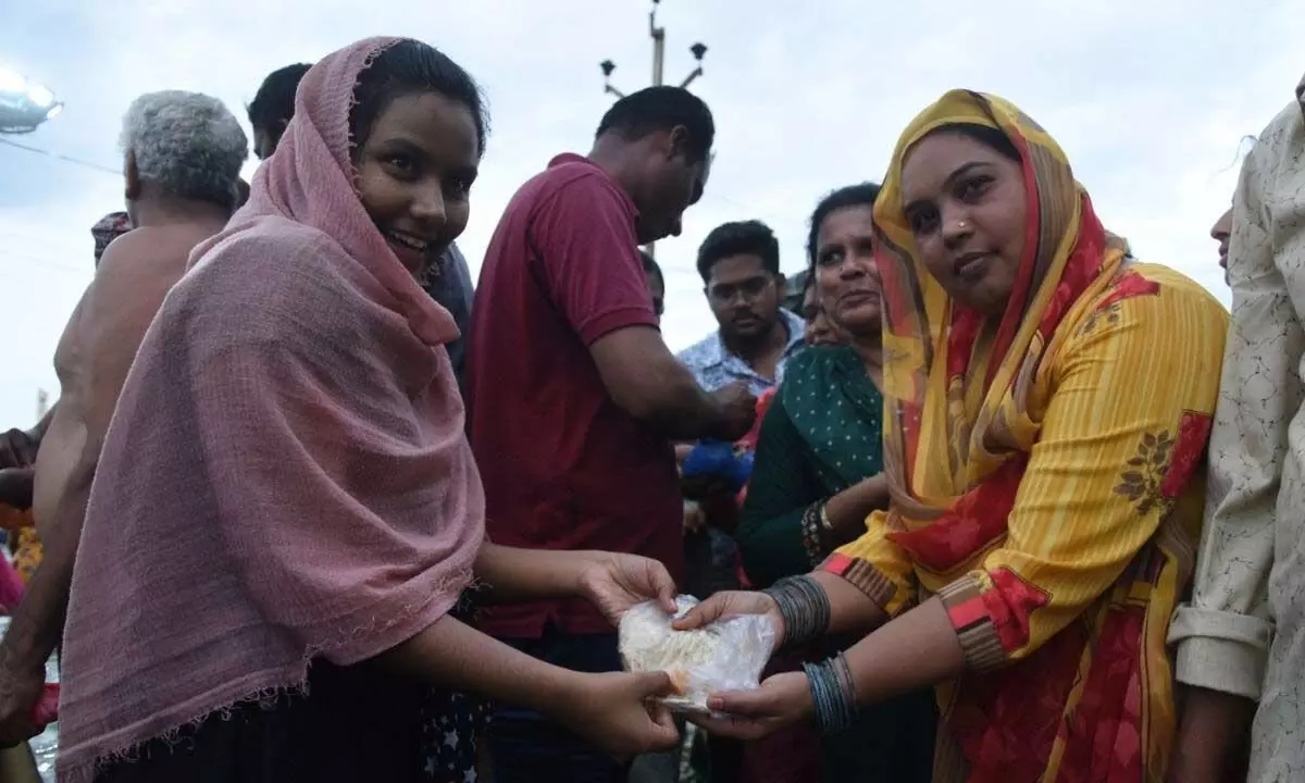 Women exchanging  rotis at Barashaheed dargah  on Tuesday